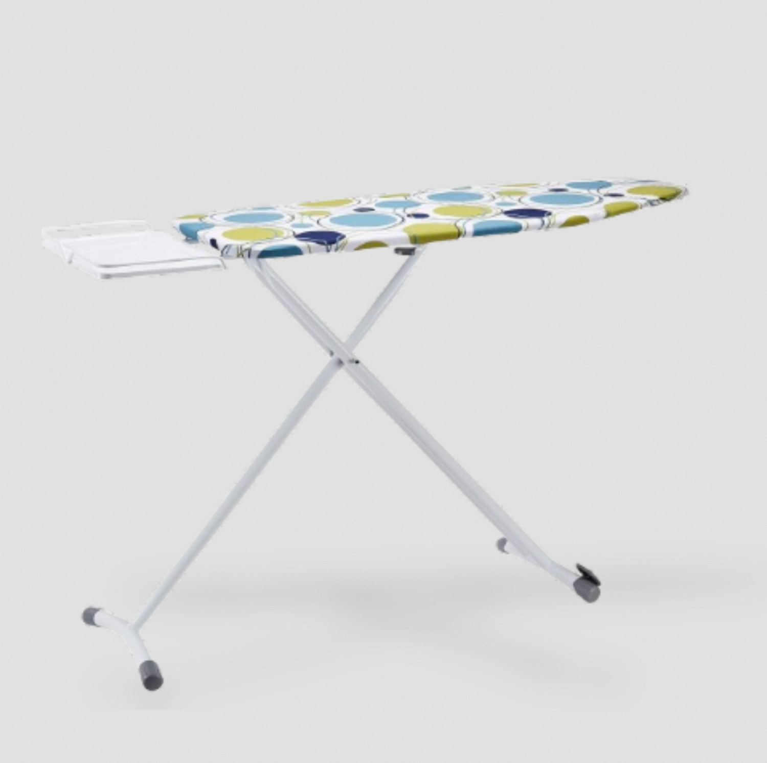 White ironing board with blue and green circles print cover, integrated iron rest and X-frame legs, three-quarter view