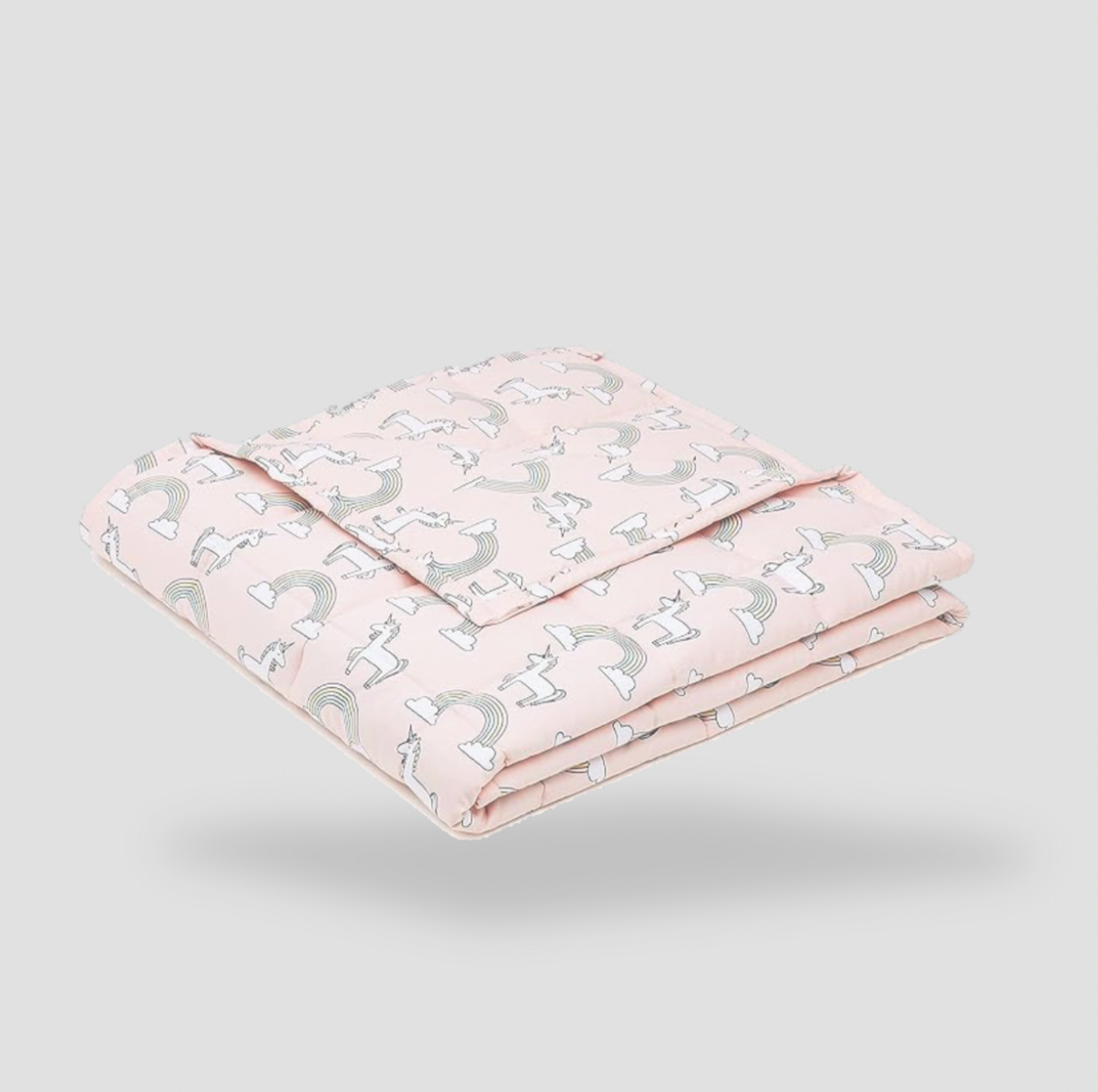Folded pink unicorn kids cotton weighted blanket on white background, product view