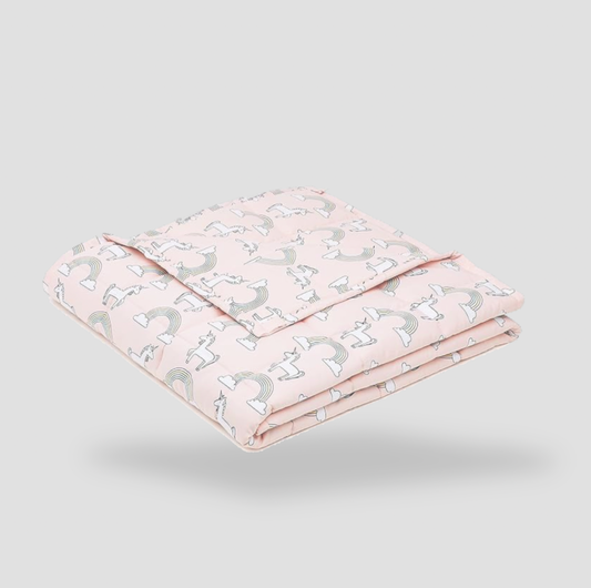 Folded pink unicorn kids cotton weighted blanket on white background, product view