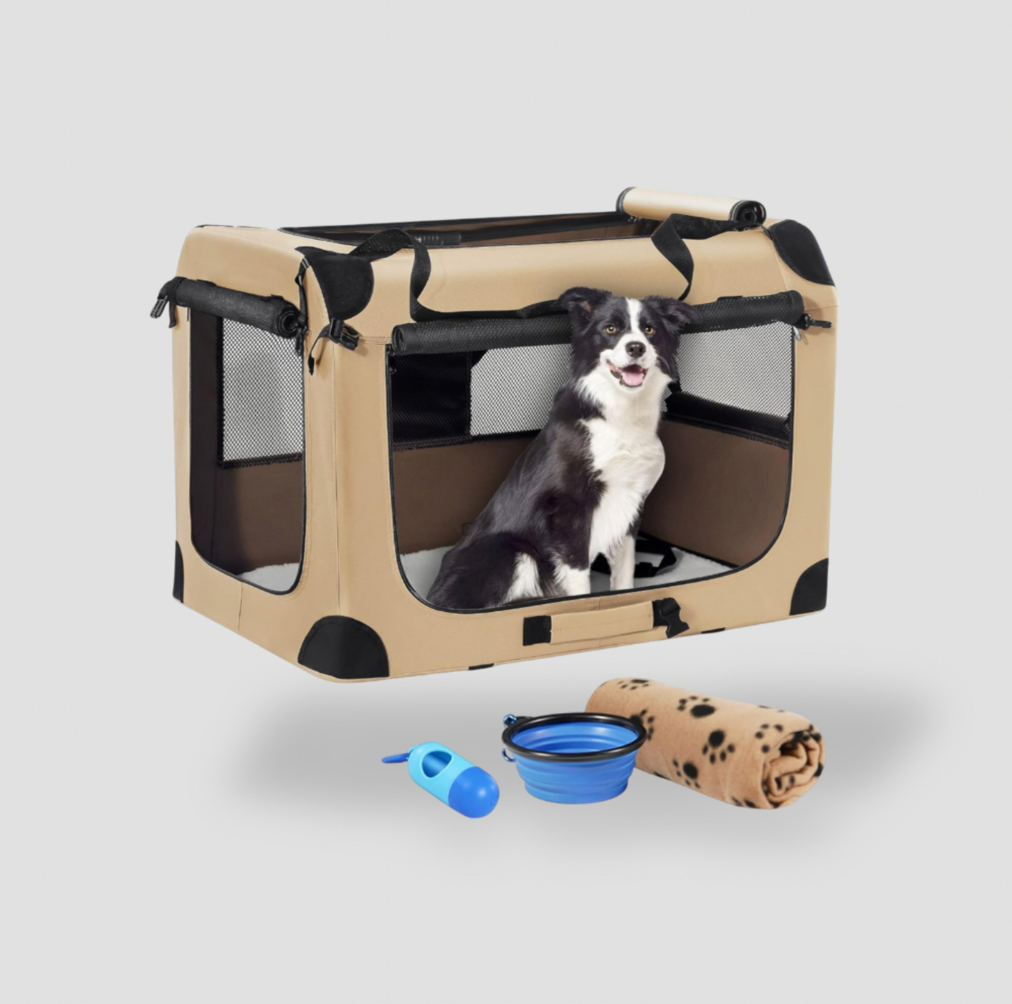 Border collie assis dans une cage de voyage souple beige tan pour chien avec bol pliable et couverture