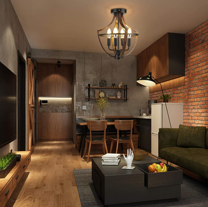 Lustre suspendu cage illuminant un coin repas de loft industriel avec mur en briques apparentes, table en bois, chaises et canapé vert