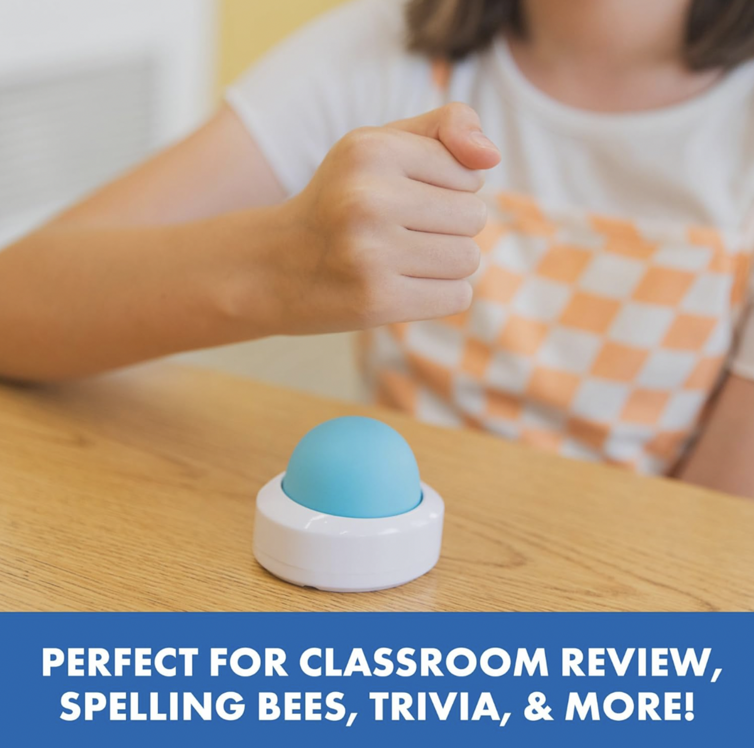 Enfant tendant la main pour appuyer sur le buzzer dôme bleu sans fil Eggspert posé sur un bureau en bois, mention Perfect for Classroom Review, Spelling Bees, Trivia