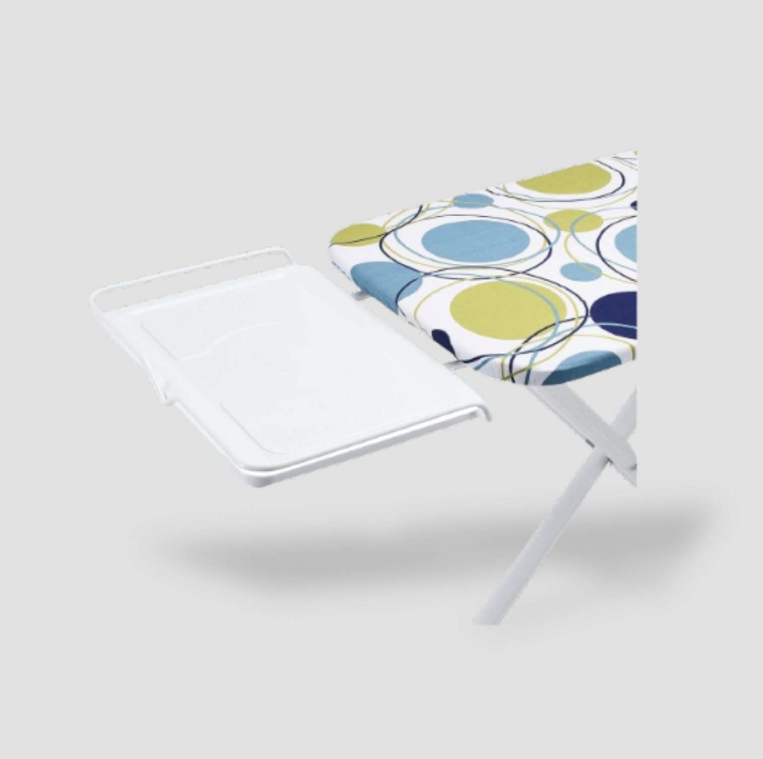 Close-up of white iron rest tray attached to circles print ironing board