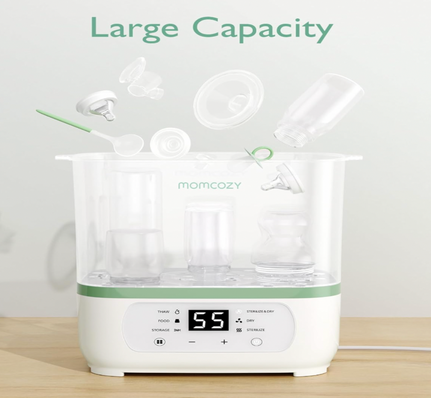 Stérilisateur Momcozy chargé de biberons, tétines et accessoires flottants, mention Large Capacity au-dessus de l'appareil blanc et vert