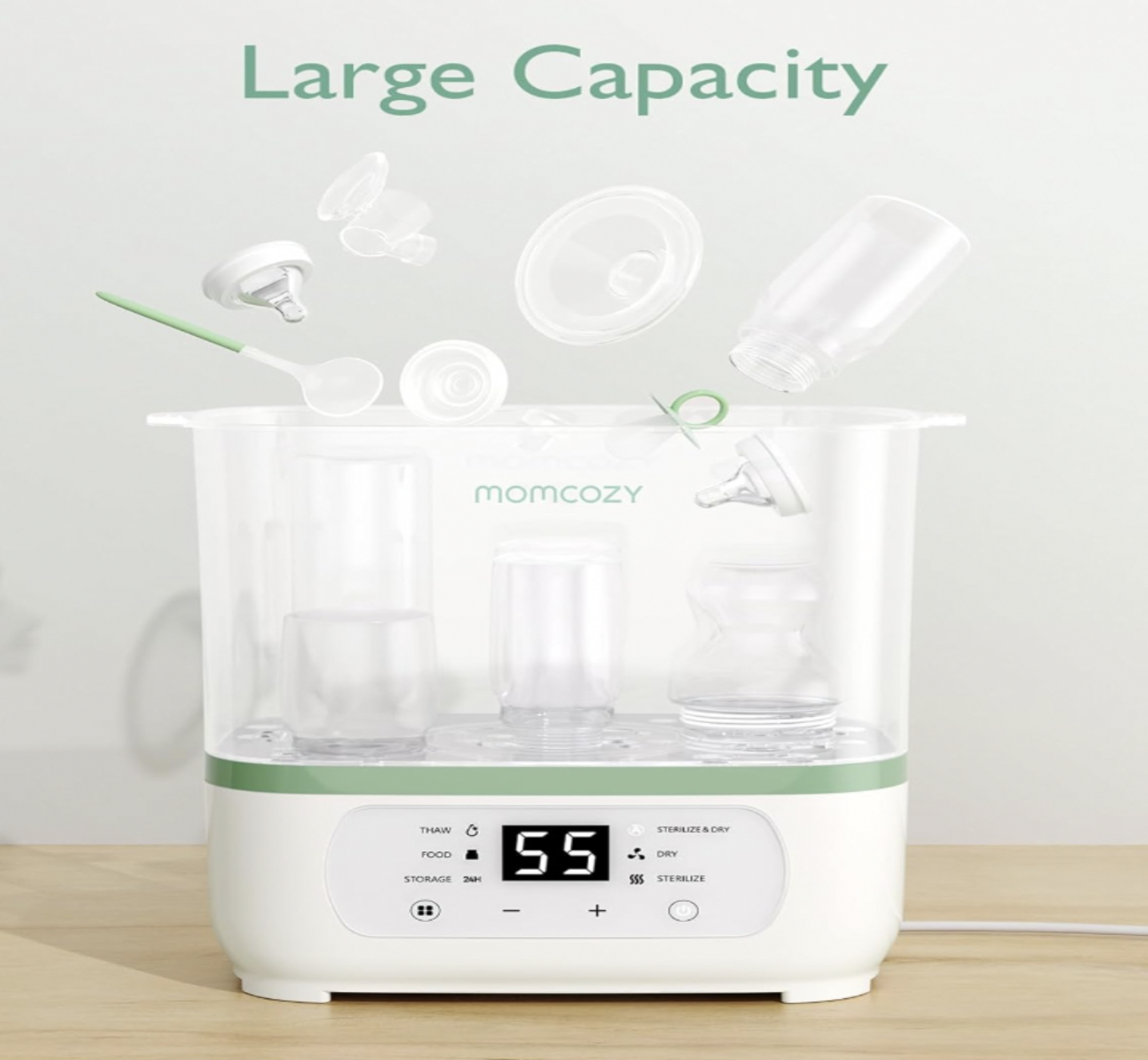 Stérilisateur Momcozy chargé de biberons, tétines et accessoires flottants, mention Large Capacity au-dessus de l'appareil blanc et vert