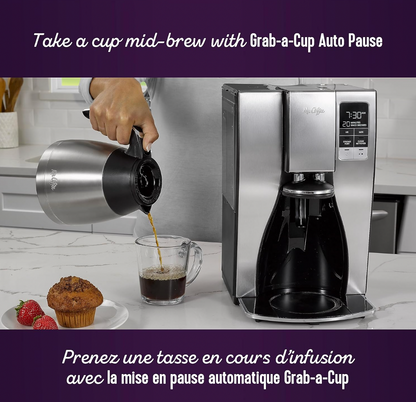 Main soulevant la carafe thermique en acier inoxydable de la cafetière Mr. Coffee pour verser dans une tasse en verre à côté d'un muffin au chocolat, mention Grab-a-Cup Auto Pause