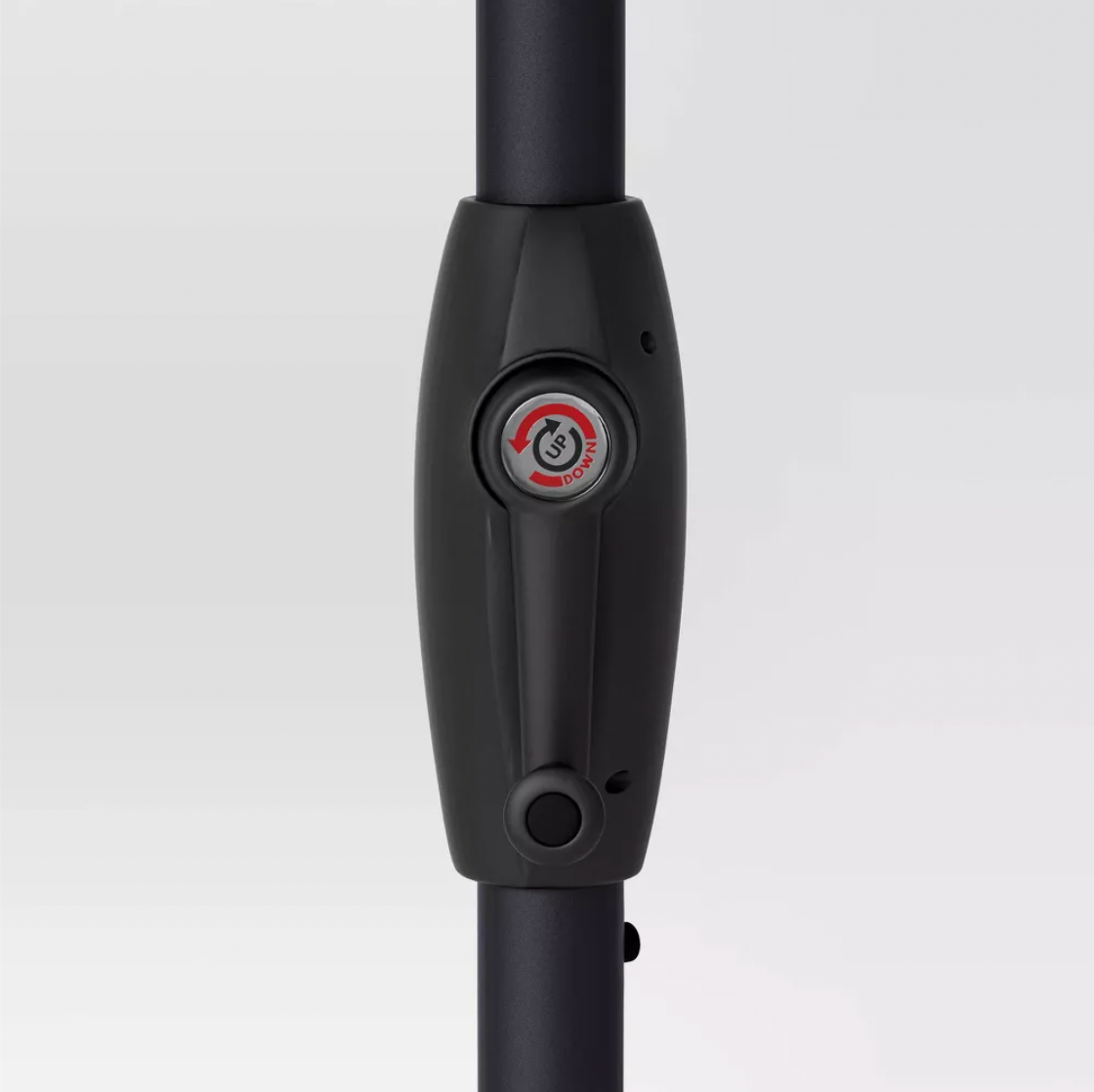 Close-up of black umbrella pole with up-down push-button tilt mechanism