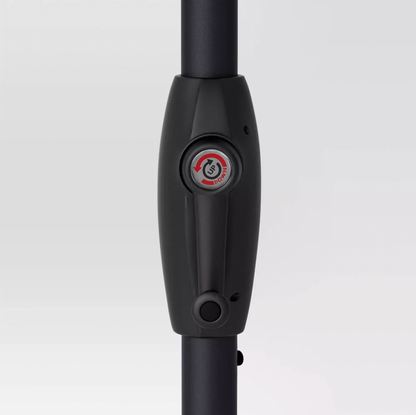 Close-up of black umbrella pole with up-down push-button tilt mechanism