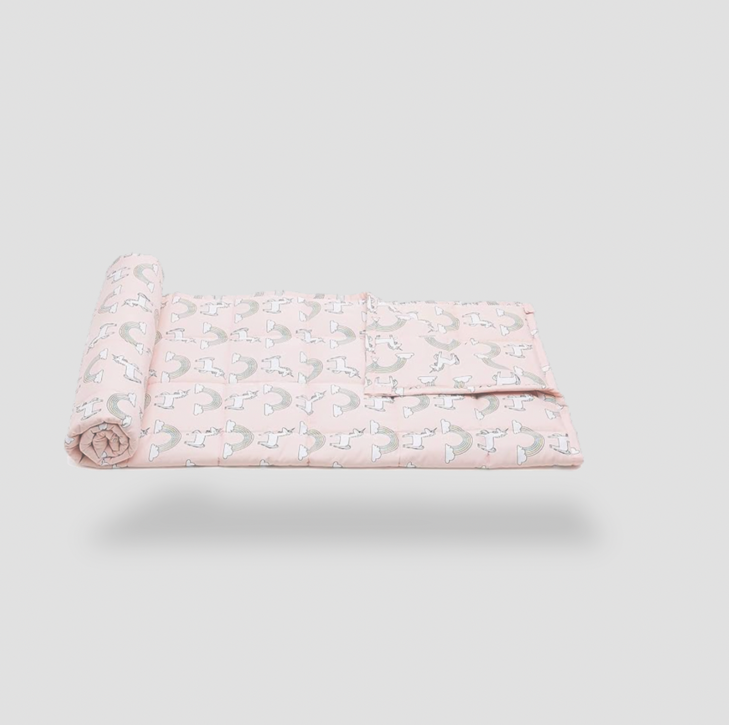 Half-rolled pink unicorn print weighted blanket on white background, side view