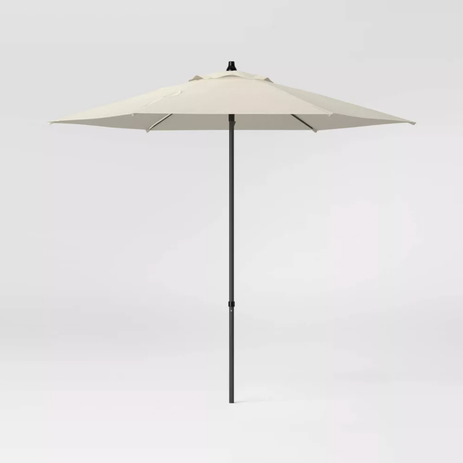 Room Essentials beige round patio umbrella with black pole and crank, full product front view