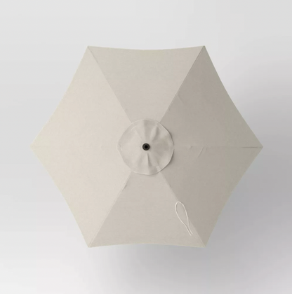 Top-down view of six-panel beige patio umbrella canopy with center vent