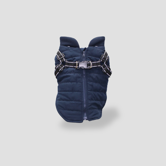 Navy puffer dog jacket with built-in reflective harness straps and silver buckle, front view