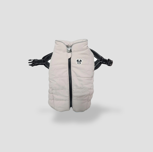 Beige puffer dog jacket with built-in black harness straps and paw print logo, front view