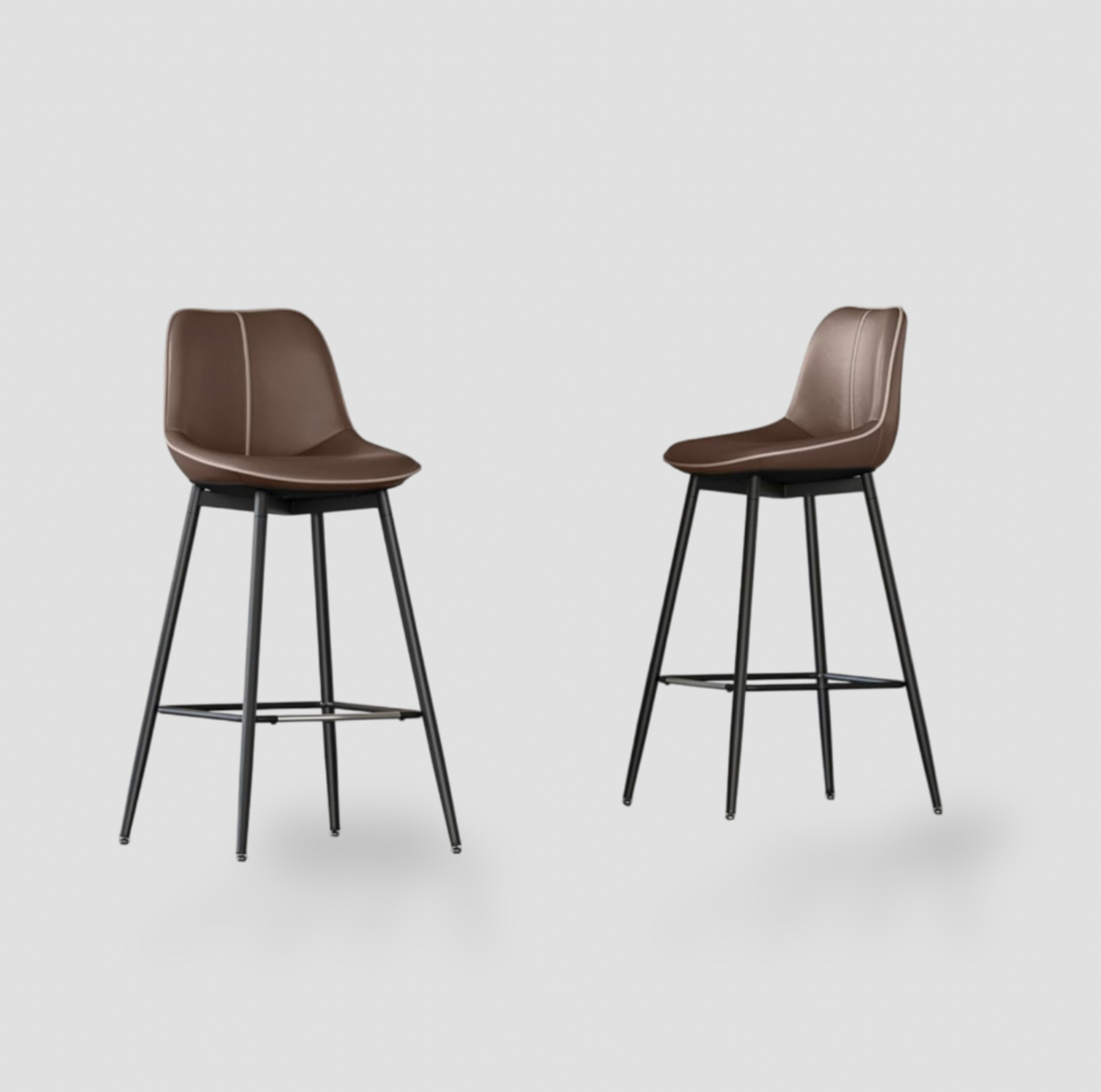 Pair of coffee brown synthetic leather bar stools with curved backrest, contrast piping and black metal four-leg base with footrest