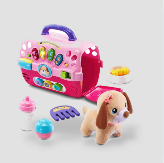 Pink VTech pet carrier toy with plush puppy, brush, bottle, ball and food bowl accessories