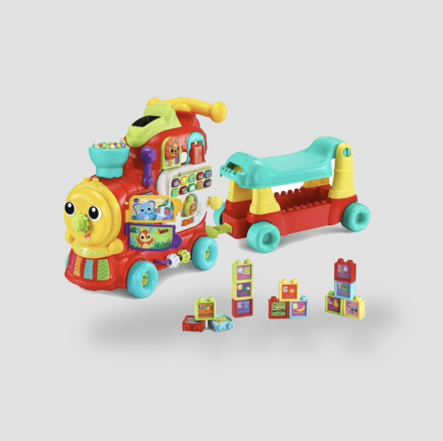 Red VTech learning train with wagon and stacking alphabet blocks scattered beside it