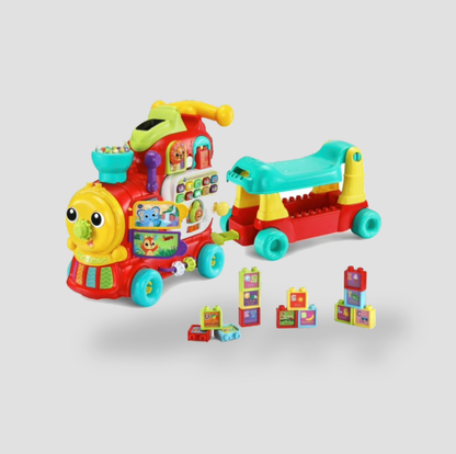 Red VTech learning train with wagon and stacking alphabet blocks scattered beside it